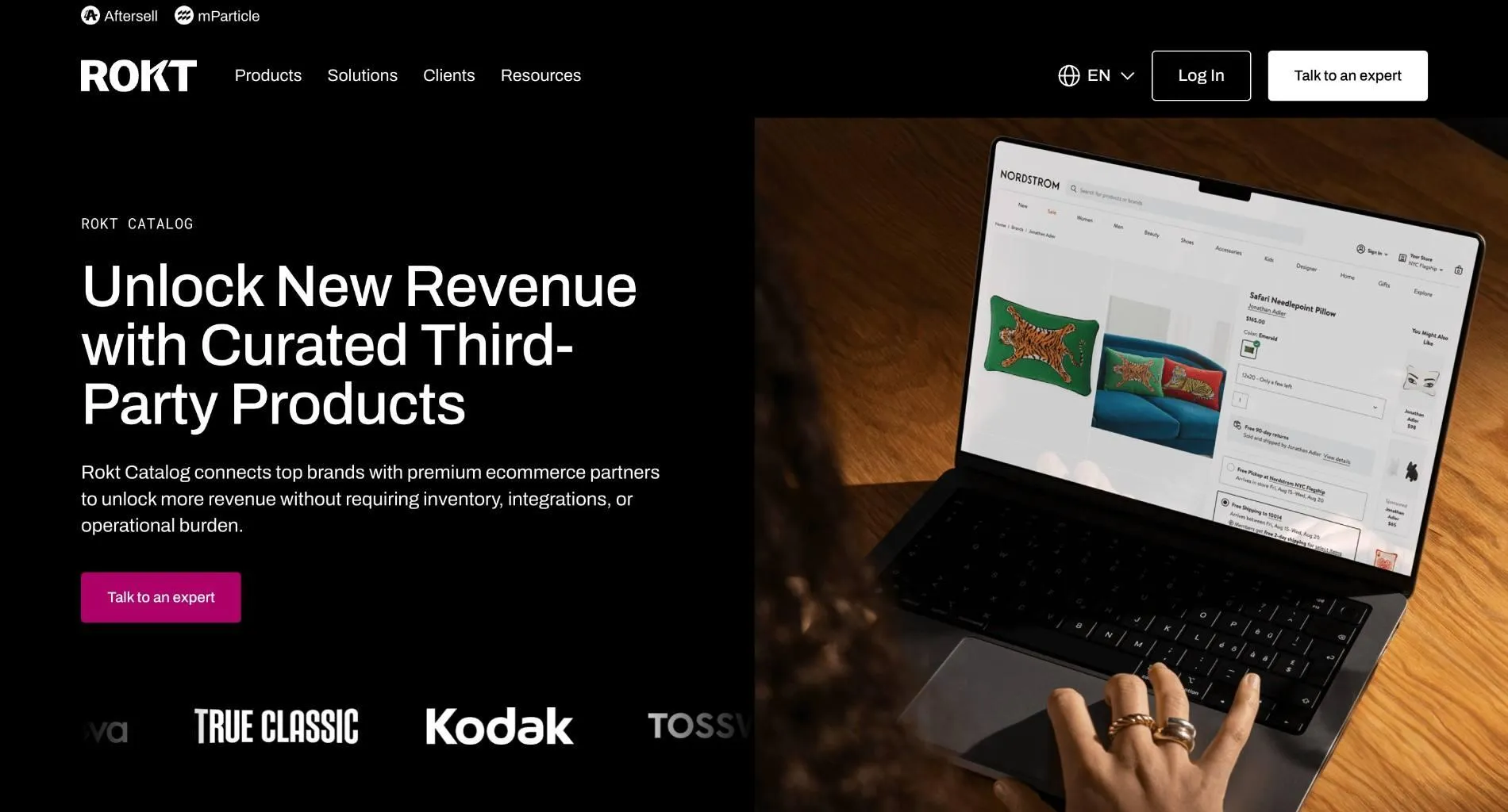 Rokt Catalog homepage with the headline 'Unlock New Revenue with Curated Third-Party Products' beside a laptop showing a Nordstrom product page.