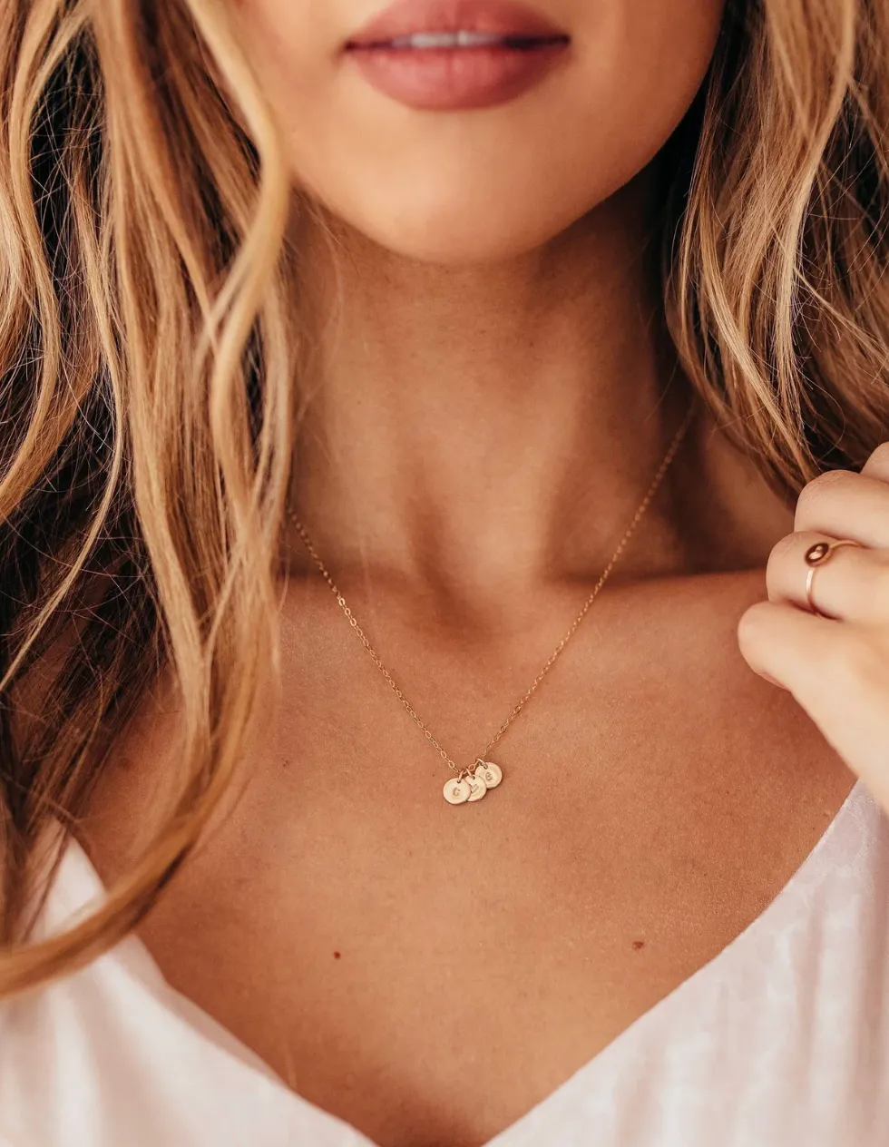 Gold-tone chain necklace with three small initial disc charms