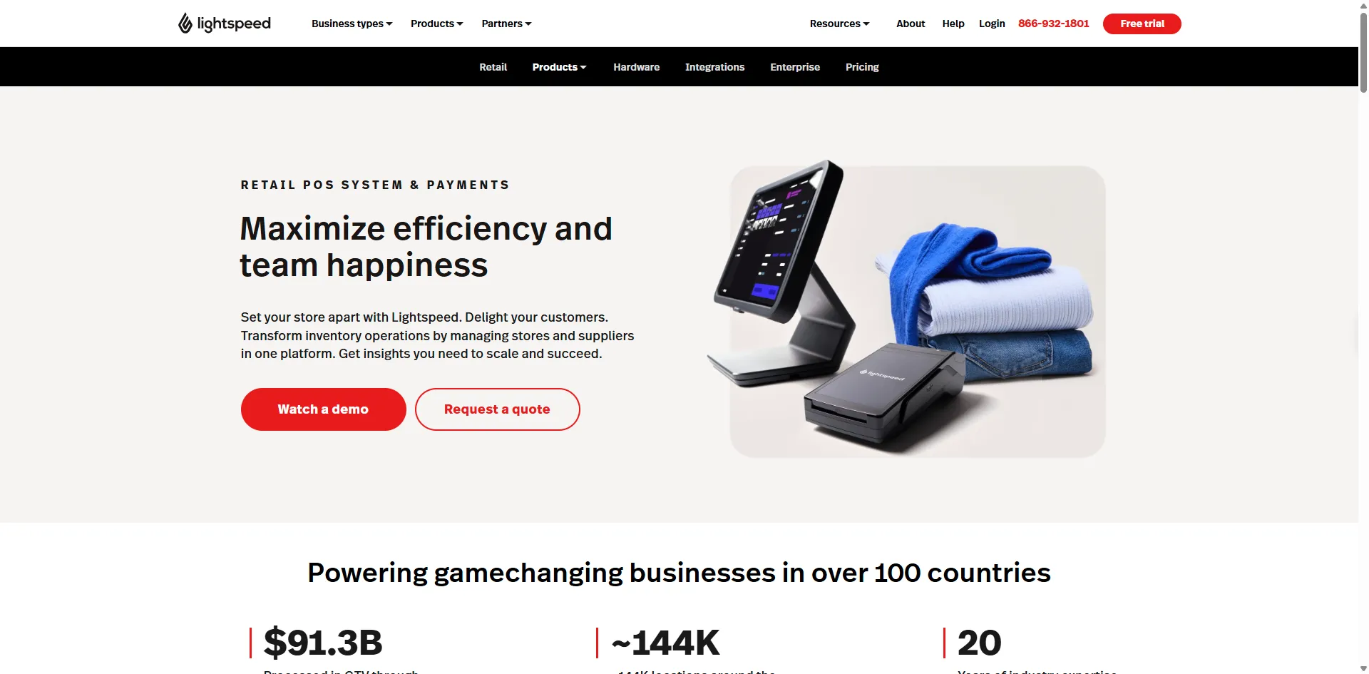 Lightspeed Retail homepage showing a POS terminal and card reader beside folded clothes