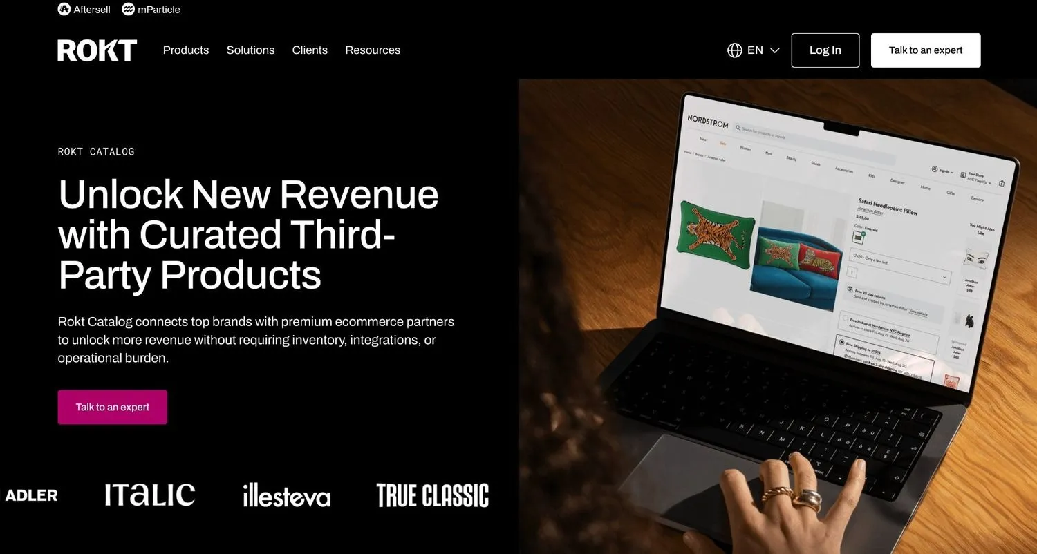 Rokt Catalog homepage with a laptop showing a Nordstrom product page for a needlepoint pillow