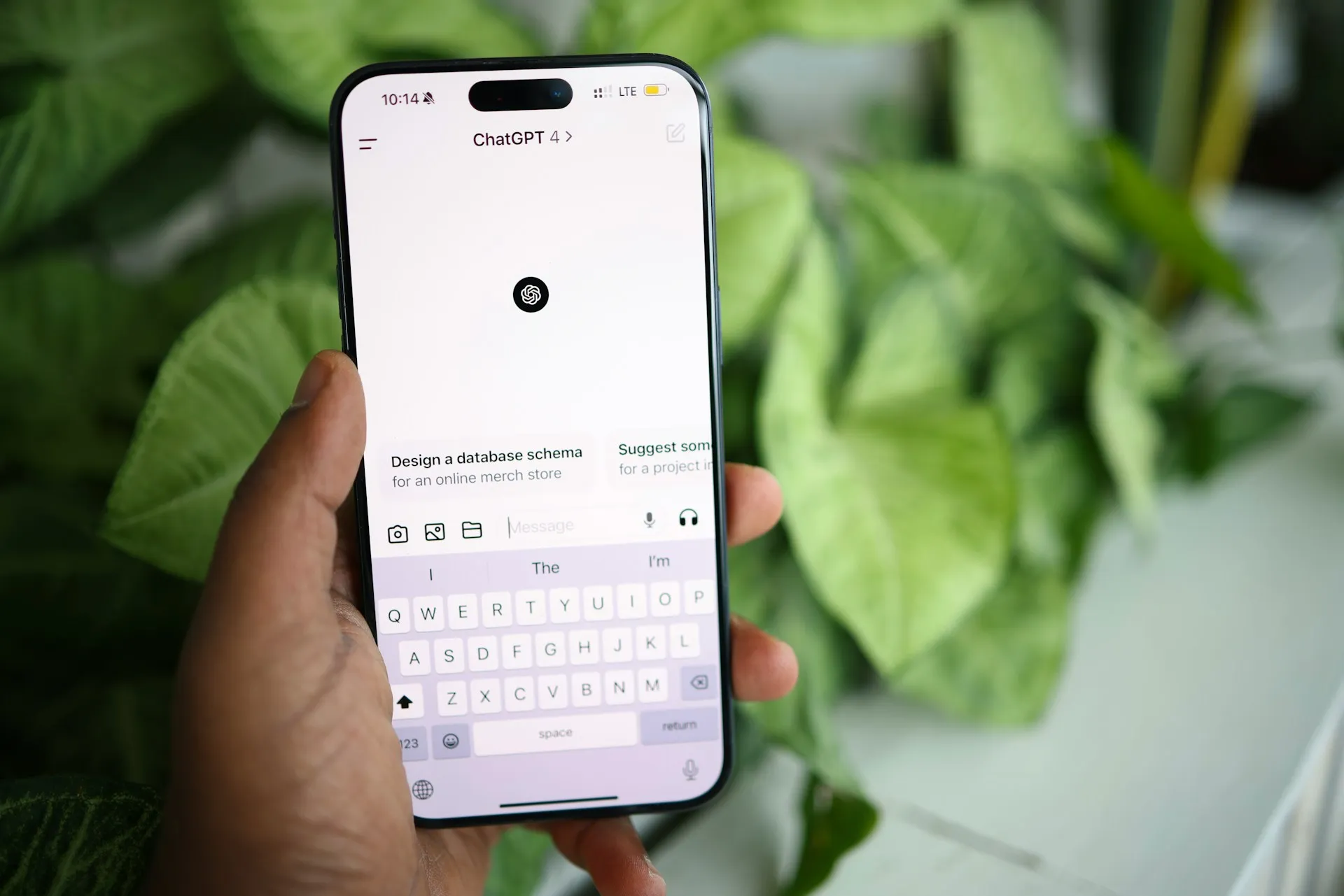 Hand holding a phone with the ChatGPT app open