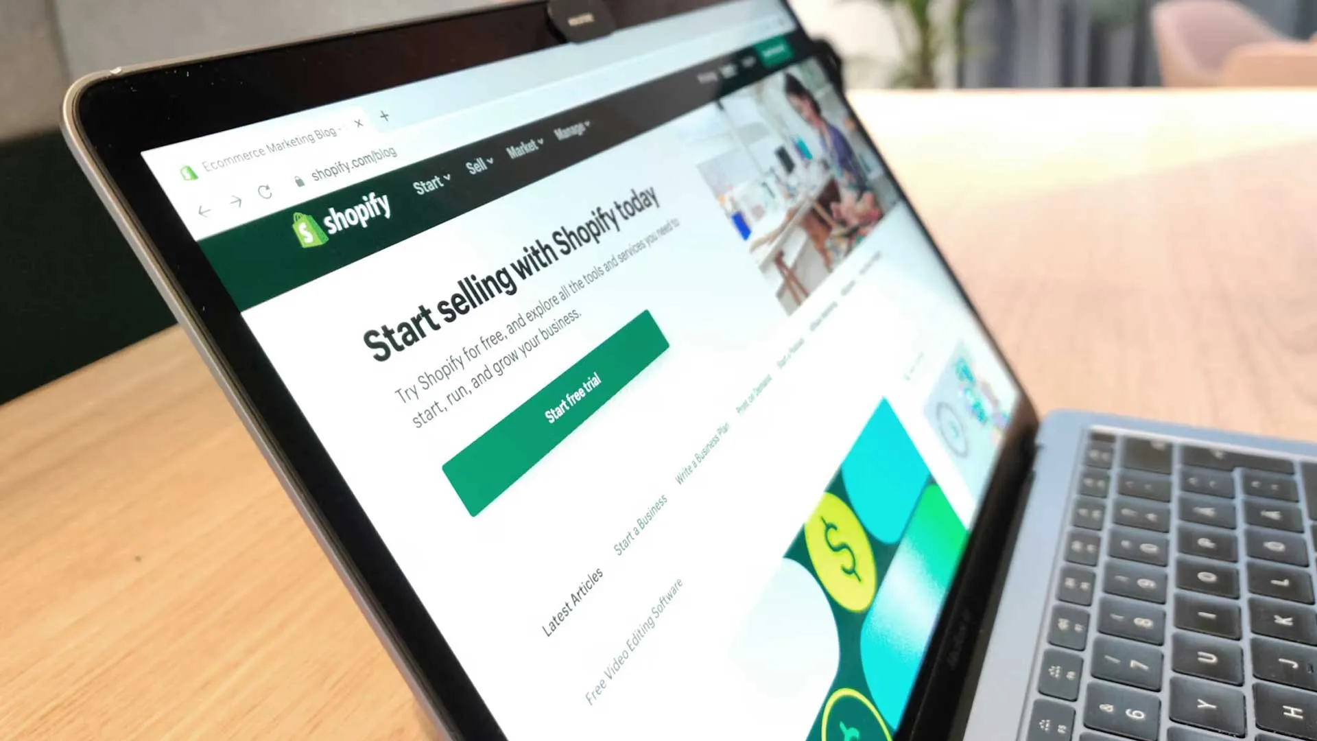Laptop open to a Shopify page with a Start free trial button